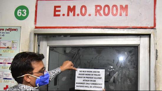 Doctors paste posters on a door at emergency ward asking for a strike to protest the incident. (Sameer Sehgal/HT) Doctors paste posters on a door at emergency ward asking for a strike to protest the incident. (Sameer Sehgal/HT)