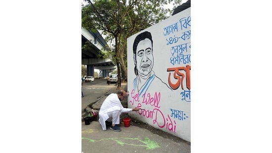 TMC candidate for Kasba constituency Javed Ahmed Khan writes wall graffiti for a speedy recovery of CM Mamata Banerjee, in Kolkata on March 11.(ANI)