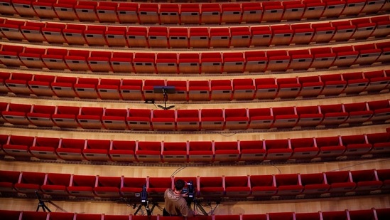 A cameraman prepares for the video recording of "Despo-Greek Dances" Opera and dance performance at the empty Greek National Opera in Athens, Saturday, March 6, 2021. (AP)