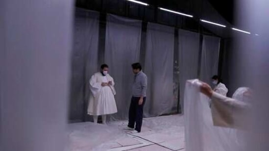 Actors Marios Panagiotou, left, and Konstantinos Arnokouros speak, during a rehearsal of "The Free Besieged" at the Greek National Theater in Athens, Tuesday, March 2, 2021. (AP)