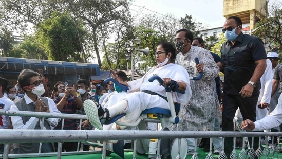 TMC leader Aroop Biswas pulls the wheelchair of WB CM and TMC Supremo Mamata Banerjee during 'Nandigram Diwas'rally at Hazra crossing from Gandhi Statue, in Kolkata (PTI) TMC leader Aroop Biswas pulls the wheelchair of WB CM and TMC Supremo Mamata Banerjee during 'Nandigram Diwas'rally at Hazra crossing from Gandhi Statue, in Kolkata (PTI)