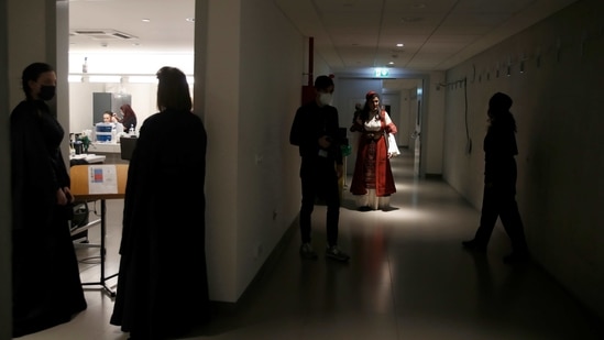 Soprano Artemis Bogri wearing a Greek traditional costume prepares with others for the rehearsal of "Despo-Greek Dances" Opera and dance performance in Athens, Thursday, March 4, 2021. (AP)