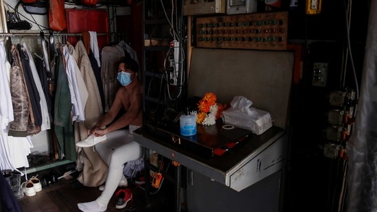 Actor Konstantinos Arnokouros wearing a face mask, prepares, prior to a rehearsal of "The Free Besieged" at the Greek National Theater in Athens, Tuesday, March 2, 2021. (AP)