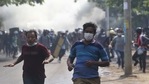 Anti-coup protesters escape security forces firing tear gas in Mandalay.(AP) Anti-coup protesters escape security forces firing tear gas in Mandalay.(AP)