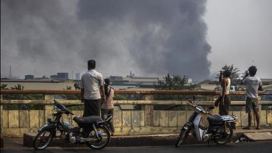 Smoke billows from the industrial zone of Hlaing Thar Yar township in Yangon, Myanmar on March 14, 2021. Attacks on Chinese-run factories in Myanmar's biggest city drew demands on Monday from Beijing for protection for their property and employees. (AP) Smoke billows from the industrial zone of Hlaing Thar Yar township in Yangon, Myanmar on March 14, 2021. Attacks on Chinese-run factories in Myanmar's biggest city drew demands on Monday from Beijing for protection for their property and employees. (AP)