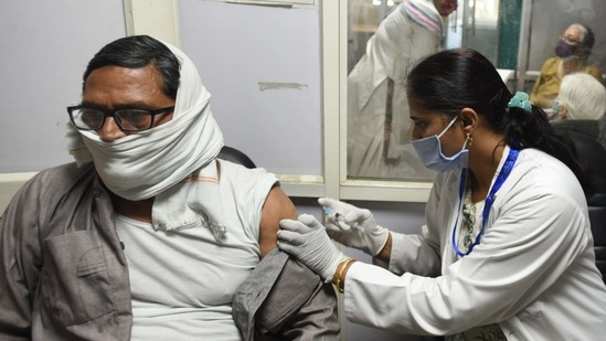 A health worker vaccinates a man against coronavrus disease (Covid-19), at District Hospital, Sector 30, in Noida.(Sunil Ghosh / HT file photo)
