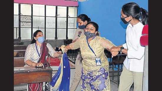 Police personnel removing the staff from Holy Christ School before LIT sealed the property. (Gurpreet Singh/HT)