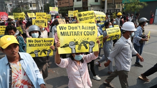 Anti-coup protesters display signs during a protest against the military coup in Mandalay, Myanmar. (AP) Anti-coup protesters display signs during a protest against the military coup in Mandalay, Myanmar. (AP)