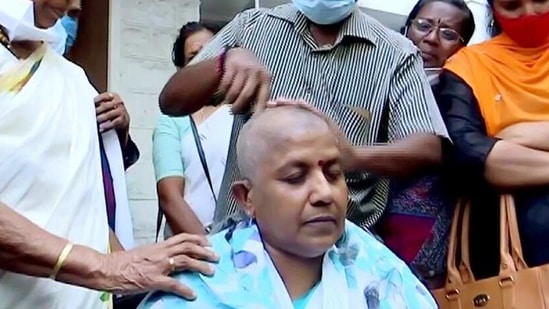 Kerala Mahila Congress Chief Lathika Subhash gets her head tonsured in front of the party office after being denied the party ticket for the assembly election, in Thiruvananthapuram on Sunday. (ANI Photo) Kerala Mahila Congress Chief Lathika Subhash gets her head tonsured in front of the party office after being denied the party ticket for the assembly election, in Thiruvananthapuram on Sunday. (ANI Photo)