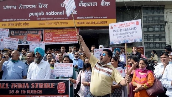 Punjab National Bank employees with posters shout slogans over various demands including privatization during the nationwide bank strike in Jalandhar on Monday. (ANI Photo) Punjab National Bank employees with posters shout slogans over various demands including privatization during the nationwide bank strike in Jalandhar on Monday. (ANI Photo)