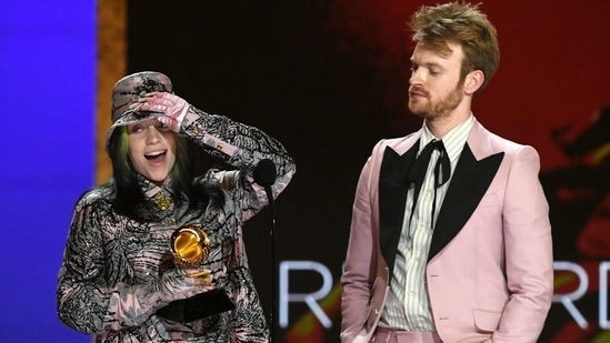 Singer-songwriter Billie Eilish and her brother Finneas accept the Record of the Year award for 'Everything I Wanted' onstage at the 63rd Grammy Awards. Eilish and her brother Finneas also won the best song written for visual media award for their James Bond theme from the unreleased "No Time to Die" movie. It was for the first time ever that a track from an unreleased film won the award.(Kevin Winter/The Recording Academy/AFP)