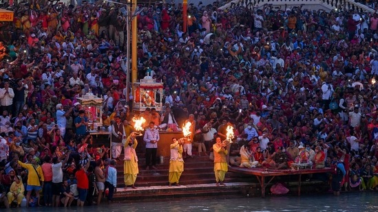 Hindu devotees attend evening prayers after taking a holy dip in the waters of the River Ganges on the Shahi Snan (grand bath) on the occasion of the Maha Shivratri festival during the ongoing religious Kumbh Mela festival in Haridwar on March 11, 2021.(AFP) Hindu devotees attend evening prayers after taking a holy dip in the waters of the River Ganges on the Shahi Snan (grand bath) on the occasion of the Maha Shivratri festival during the ongoing religious Kumbh Mela festival in Haridwar on March 11, 2021.(AFP)