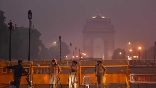 A person using an electric scooter inquires from police personnel manning barricades on Rajpath near India Gate in New Delhi on Saturday, December 12, 2020.(Sanchit Khanna/HT PHOTO) A person using an electric scooter inquires from police personnel manning barricades on Rajpath near India Gate in New Delhi on Saturday, December 12, 2020.(Sanchit Khanna/HT PHOTO)