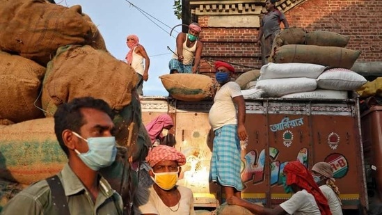 Labourers wear protective face masks at a wholesale market in Kolkata.(REUTERS)
