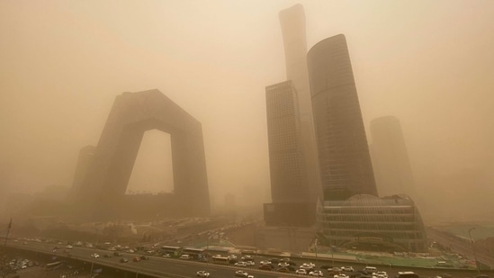 High-rise buildings engulfed in a thick layer of smog in the central business district of Beijing during a sandstorm on March 15. Beijing was cloaked in thick smog on March 15 with pollution levels surging off the charts as the worst sandstorm in a decade descended on China's capital from the Gobi desert.(Leo Ramirez / AFP)