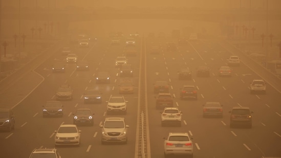 Vehicles are seen on an expressway during the sandstorm in Beijing, on March 15.(Mark Schiefelbein / AP)