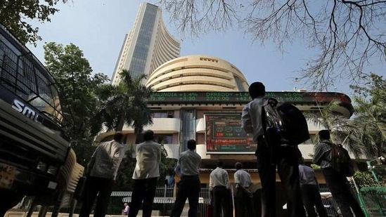 People look at a screen displaying the Sensex results on the facade of the Bombay Stock Exchange (BSE) building in Mumbai. (REUTERS)