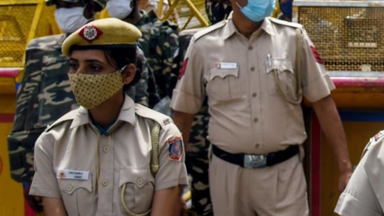 Police personnel including women police stand guard during a demonstration(ANI Photo) Police personnel including women police stand guard during a demonstration(ANI Photo)