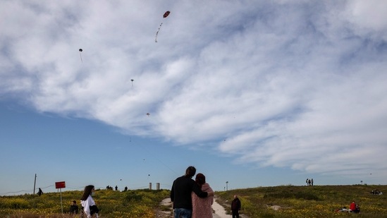 A couple flies a kite in Drapetsona suburb of Piraeus, near Athens, on Sunday, March 14, 2021. The coronavirus pandemic, which hit Cyprus, and Greece especially hard this winter, threatened to ground the kite-flying, an essential part of the celebration of Clean Monday, the first day of Lent.(AP)