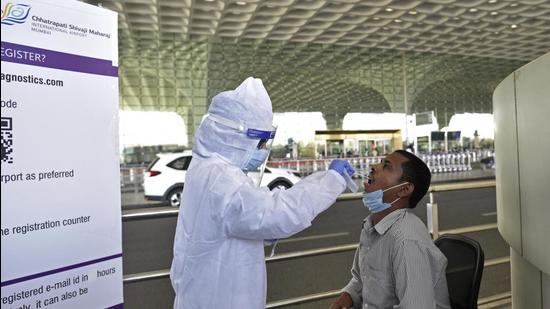 Mumbai, India - November 25, 2020: Healthcare workers during COVID-19 screening and swab test of passengers at Chhatrapati Shivaji Maharaj International Airport, Andheri in Mumbai, India, on Wednesday, November 25, 2020. (Photo by Satyabrata Tripathy/Hindustan Times) (Satyabrata Tripathy/HT Photo) Mumbai, India - November 25, 2020: Healthcare workers during COVID-19 screening and swab test of passengers at Chhatrapati Shivaji Maharaj International Airport, Andheri in Mumbai, India, on Wednesday, November 25, 2020. (Photo by Satyabrata Tripathy/Hindustan Times) (Satyabrata Tripathy/HT Photo)