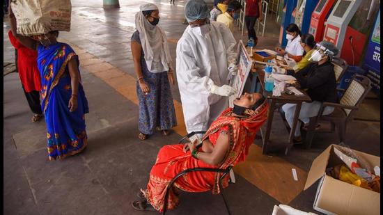A medic takes a swab sample for Covid-19 testing, at Turbhe Railway Station in Navi Mumbai on March 15. (PTI) A medic takes a swab sample for Covid-19 testing, at Turbhe Railway Station in Navi Mumbai on March 15. (PTI)