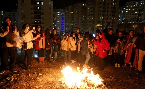Iranian families light fire outside their houses in Tehran on March 16, 2021 during the Wednesday Fire feast, or Chaharshanbeh Soori, held annually on the last Wednesday eve before the Spring holiday of Noruz. ( AFP)