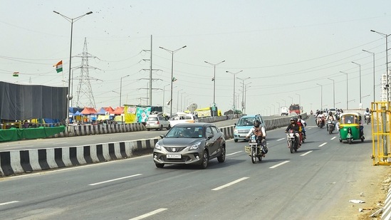 Vehicles ply on a carriageway of the NH-24 after it was reopened for the traffic, near Ghazipur border in Ghaziabad (PTI) Vehicles ply on a carriageway of the NH-24 after it was reopened for the traffic, near Ghazipur border in Ghaziabad (PTI)