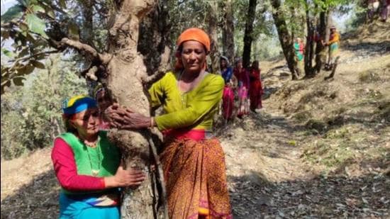 Women of Jakhani village in Uttarakhand’s Bageshwar hugged trees on Monday in Bageshwar district. (HT photo)