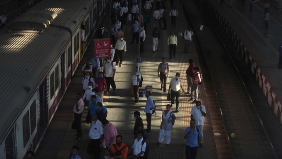 Commuters wearing masks as a precaution against the coronavirus walk at a train station in Mumbai, India, Monday, March 15, 2021.(AP)