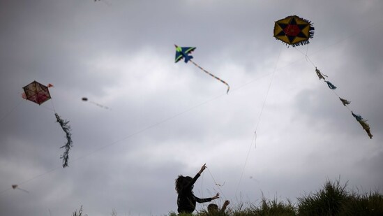 A woman flies a kite on a hill in Athens, on clean Monday, March 15, 2021. The coronavirus pandemic, which hit Cyprus, and Greece especially hard this winter, threatened to ground the kite-flying, an essential part of the celebration of Clean Monday, the first day of Lent. (AP Photo/Petros Giannakouris)(AP)