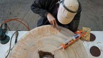 Worker processes a wood slice at the HK TimberBank factory in Hong Kong. (Reuters)