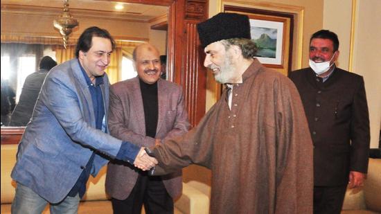 Former MP Muzaffar Baig (in brown) greets Jammu and Kashmir Peoples’ Conference chairperson Sajad Lone on Wednesday. (Source: Twitter) Former MP Muzaffar Baig (in brown) greets Jammu and Kashmir Peoples’ Conference chairperson Sajad Lone on Wednesday. (Source: Twitter)