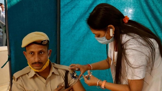 A policeman receives a dose of Covishield, a Covid-19 vaccine manufactured by the Serum Institute of India (SII), at a vaccination centre in Ahmedabad (File Photo/REUTERS).