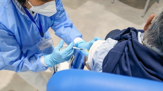A health worker administers the Moderna Inc. Covid-19 vaccine to a visitor at a Covid-19 vaccination center in Rome, Italy, on Wednesday, March 17, 2021. Europe's biggest countries, including Germany and France, suspended use of AstraZeneca Plc's Covid-19 vaccine amid a growing health scare that's creating yet another delay for the European Union's inoculation campaign. (Bloomberg) A health worker administers the Moderna Inc. Covid-19 vaccine to a visitor at a Covid-19 vaccination center in Rome, Italy, on Wednesday, March 17, 2021. Europe's biggest countries, including Germany and France, suspended use of AstraZeneca Plc's Covid-19 vaccine amid a growing health scare that's creating yet another delay for the European Union's inoculation campaign. (Bloomberg)