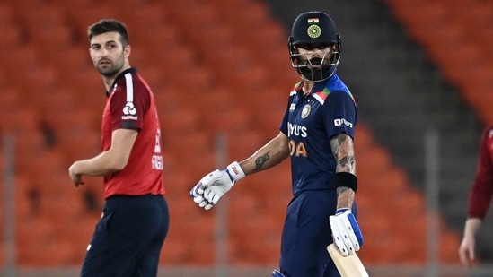 India's captain Virat Kohli (R), England pacer Mark Wood during the third T20I(AFP)