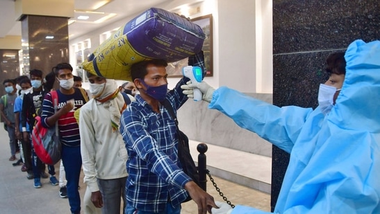 A health worker conducts thermal screening of a passenger at CSMT Railway Station in Mumbai. (PTI)
