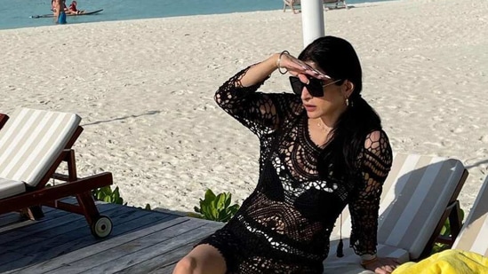 Maheep Kapoor shielding her eyes against the sun.