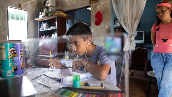 Samuel Andres Mendoza looks at a picture of a Pokemon on his computer before drawing it, at his home in Barquisimeto, Venezuela, Tuesday, March 2, 2021. (AP) Samuel Andres Mendoza looks at a picture of a Pokemon on his computer before drawing it, at his home in Barquisimeto, Venezuela, Tuesday, March 2, 2021. (AP)