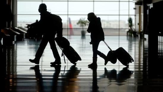 Travellers walk through the Salt Lake City International Airport, in Salt Lake City. (AP File Photo )