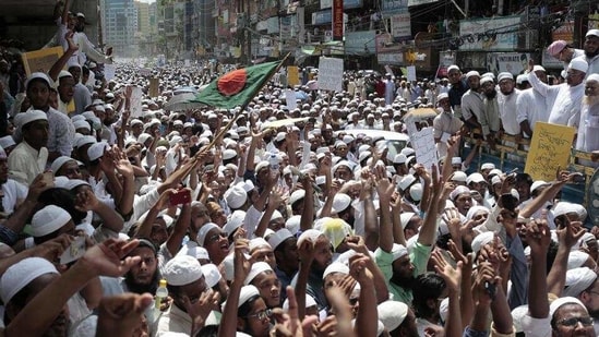 According to reports, thousands of Hefazat-e-Islam supporters attacked a Hindu village after a youth criticised the group for opposing installing a sculpture of Bangabandhu Sheikh Mujibur Rahman. In this file picture from 2017, Supporters of the hardline Hefazat-e-Islam shout slogans protesting persecution of Rohingyas at a protest march in Dhaka.(AP Photo/For Representation Purposes)