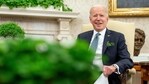 President Joe Biden sits next to a bowl of Irish shamrocks, left, as he speaks during a virtual meeting with Ireland's Prime Minister Micheal Martin on St. Patrick's Day, in the Oval Office of the White House, Wednesday, March 17, 2021, in Washington. (AP)
