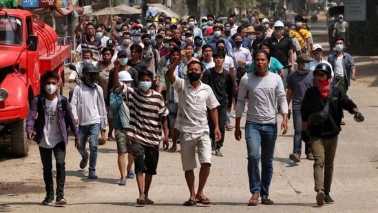 Anti-coup demonstrators gesture as they march in Nyaung-U, Myanmar on March 17, 2021. (Reuters)
