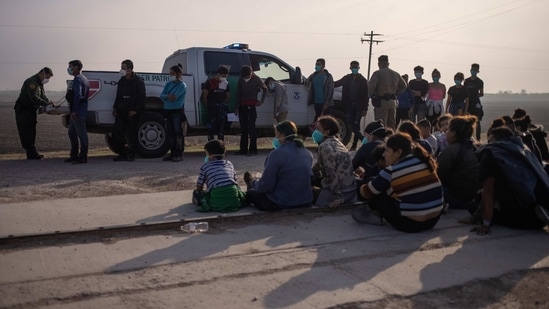 A US Border Patrol agent processes asylum-seeking unaccompanied minors as family units sit on the sideline, in Penitas, Texas, US, on March 17. According to a US official, more than 4,000 migrant children were being held by the Border Patrol as of March 14, including at least 3,000 in custody longer than the 72-hour limit set by a court-order, AP reported.(Adrees Latif / REUTERS)