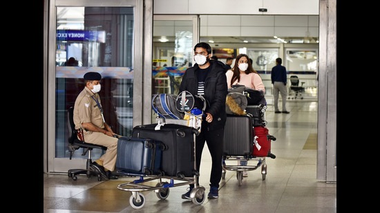 People seen wearing protective face masks as a precautionary measure amid rising coronavirus concerns, Indira Gandhi International Airport, New Delhi, March 14, 2020 (Sanjeev Verma/HT PHOTO) People seen wearing protective face masks as a precautionary measure amid rising coronavirus concerns, Indira Gandhi International Airport, New Delhi, March 14, 2020 (Sanjeev Verma/HT PHOTO)