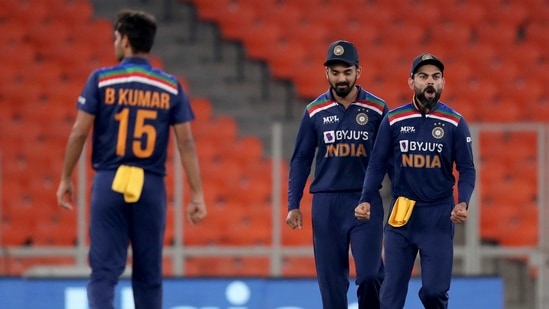 India's captain Virat Kohli, right, celebrates with teammates Bhuvneshwar Kumar, left, and KL Rahul the dismissal of England's Jos Buttler during the fourth Twenty20 cricket match between India and England at Narendra Modi Stadium in Ahmedabad, India, Thursday, March 18, 2021. (AP) India's captain Virat Kohli, right, celebrates with teammates Bhuvneshwar Kumar, left, and KL Rahul the dismissal of England's Jos Buttler during the fourth Twenty20 cricket match between India and England at Narendra Modi Stadium in Ahmedabad, India, Thursday, March 18, 2021. (AP)