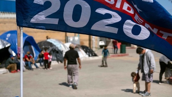 A US President Joe Biden campaign flag is seen at a migrants' camp where they wait for US authorities to allow them to start their migration process outside El Chaparral crossing port in Tijuana, Baja California state, Mexico, on March 17. Homeland Security Secretary Alejandro Mayorkas said that a surge in the number of children is a challenge for the Border Patrol and other agencies amid the coronavirus pandemic. (Guillermo Arias / AFP)