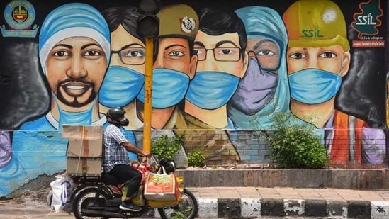 A motorist passes by a mural of frontline workers against coronavirus at RK Puram in New Delhi on July 25. Delhi’s Covid-19 recoveries have outstripped new cases on almost all days this month barring a few exceptions, after ramped-up containment and testing efforts over the past month or so. (Sanchit Khanna / HT Photo) A motorist passes by a mural of frontline workers against coronavirus at RK Puram in New Delhi on July 25. Delhi’s Covid-19 recoveries have outstripped new cases on almost all days this month barring a few exceptions, after ramped-up containment and testing efforts over the past month or so. (Sanchit Khanna / HT Photo)
