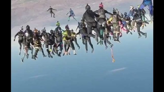 The image shows people attempting skydiving. The image shows people attempting skydiving.