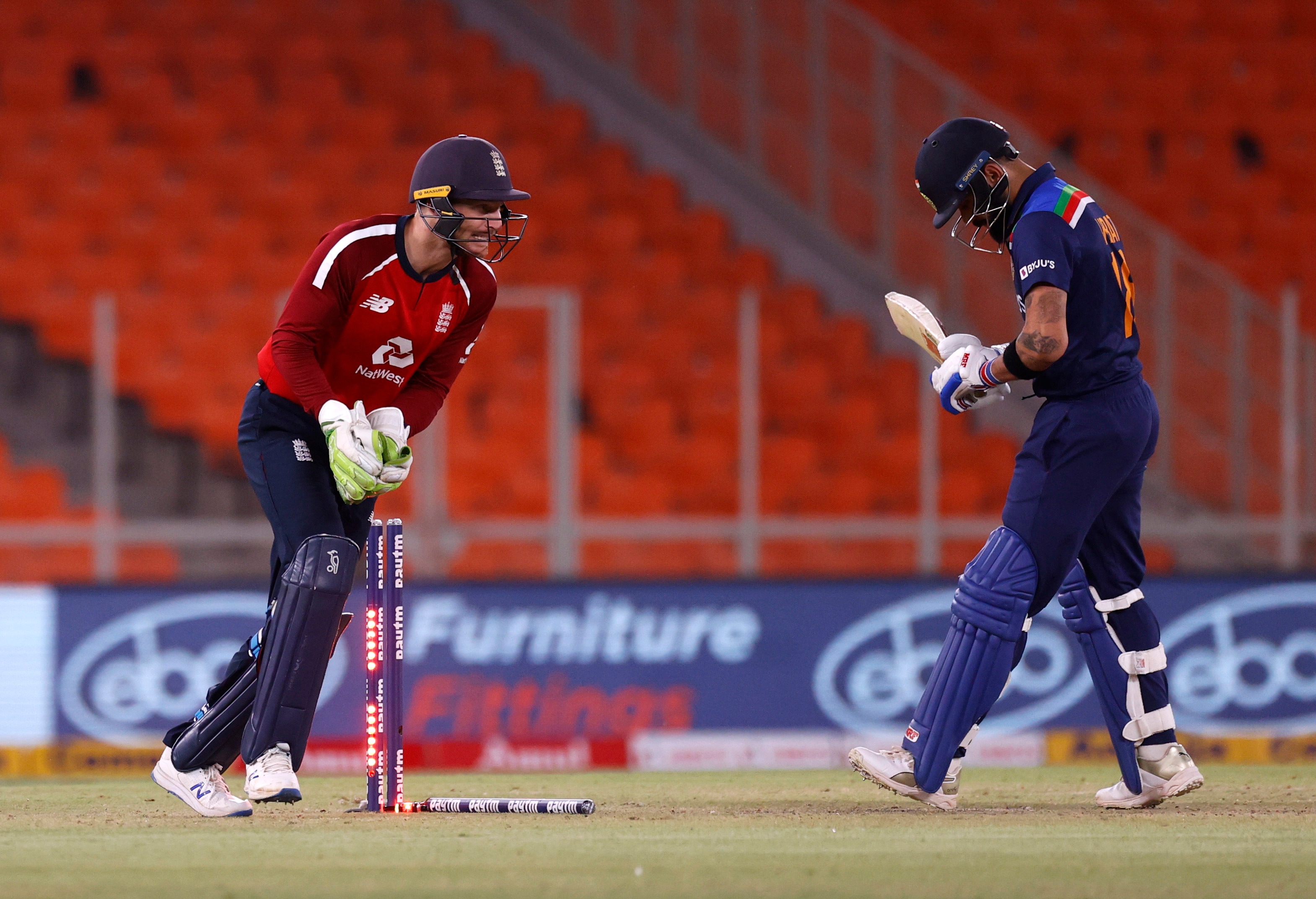 Cricket - Fourth Twenty20 International - India v England - Narendra Modi Stadium, Ahmedabad, India - March 18, 2021 England's Jos Buttler stumps India's Virat Kohli 