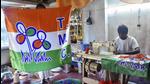A worker stitches party flags of TMC, in Howrah, earlier this month. (File photo)